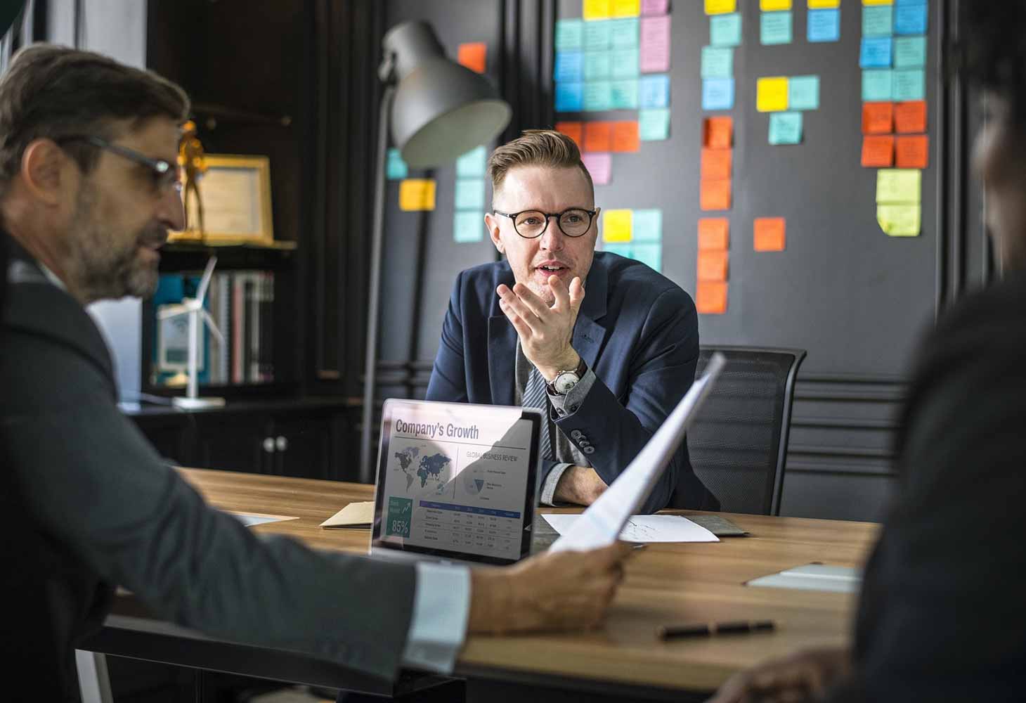 Employees sitting around a table discussing company growth