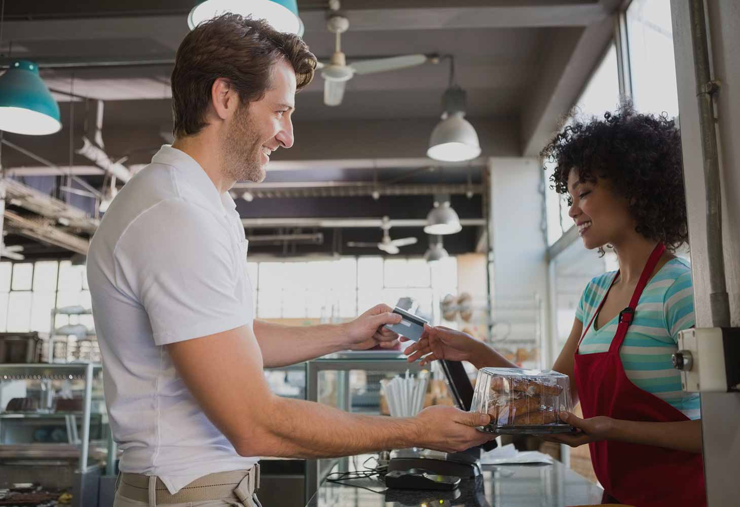 Smiling customer and employee in cafe