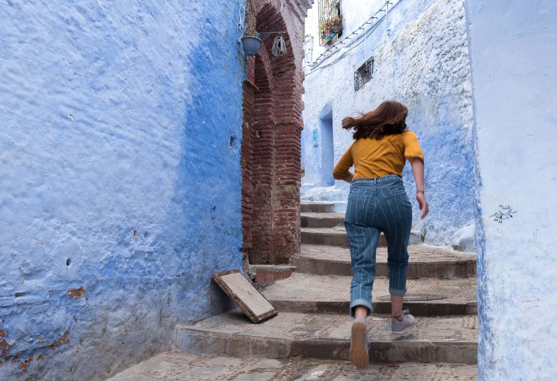 Woman running up stairs representing running away from competition