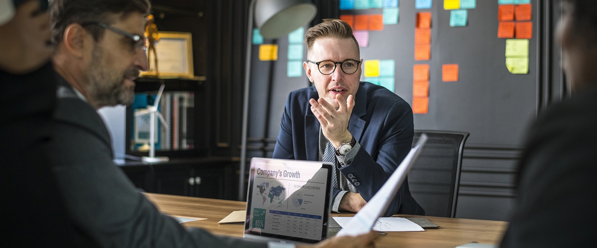 Employees sitting around a table discussing company growth