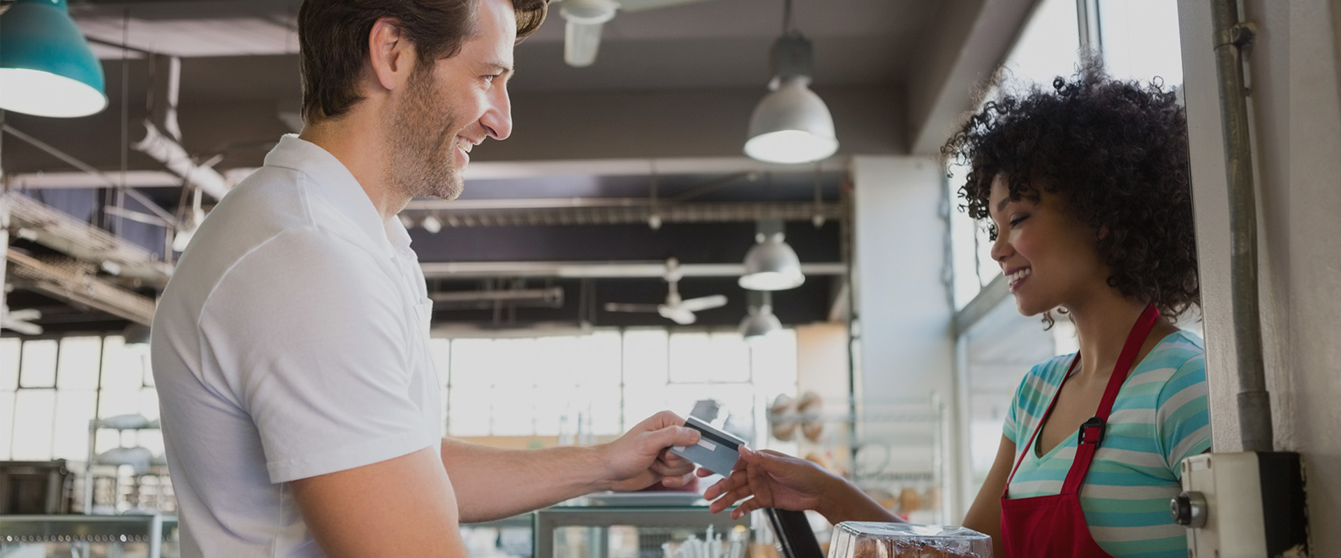 Smiling customer and employee in cafe